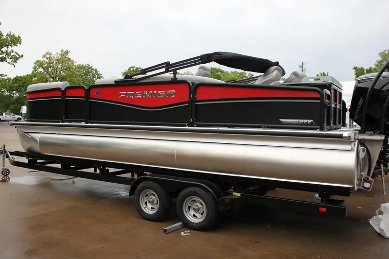 Slide: The Image of 2024 Premier 230 SunSation Angler pontoon boat on a trailer. - 13