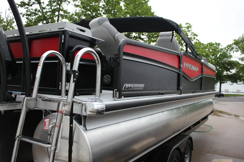 Slide: The Image of 2024 Premier 230 SunSation Angler pontoon boat with red and black exterior. - 14