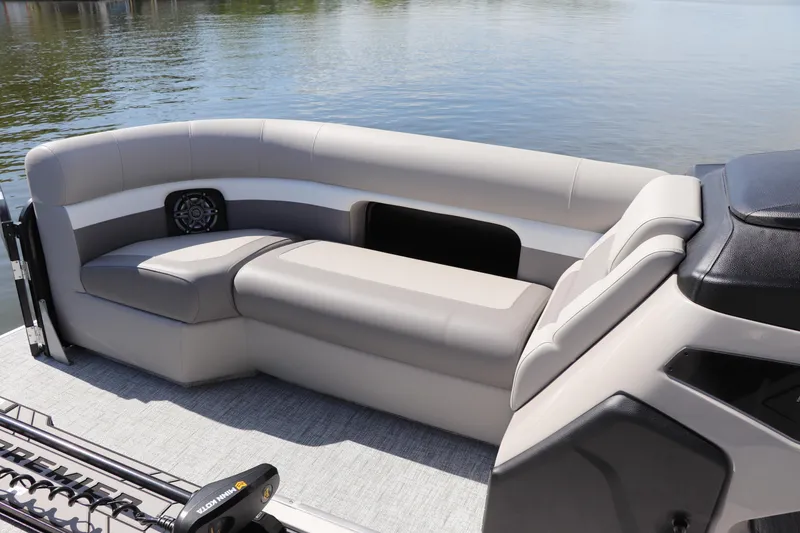Slide: The Image of 2024 Premier 230 SunSation Angler boat with comfortable seating on a calm lake. - 23