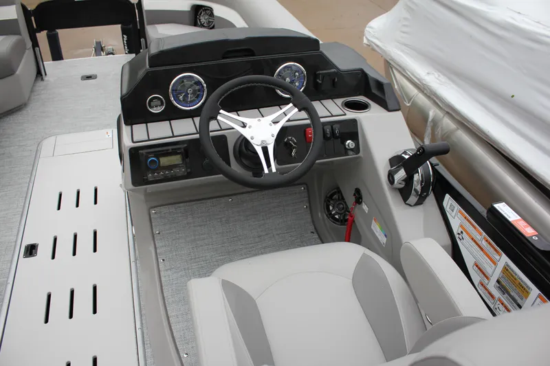 Slide: The Image of 2024 Premier 230 SunSation Angler boat cockpit with steering wheel and control panel. - 26