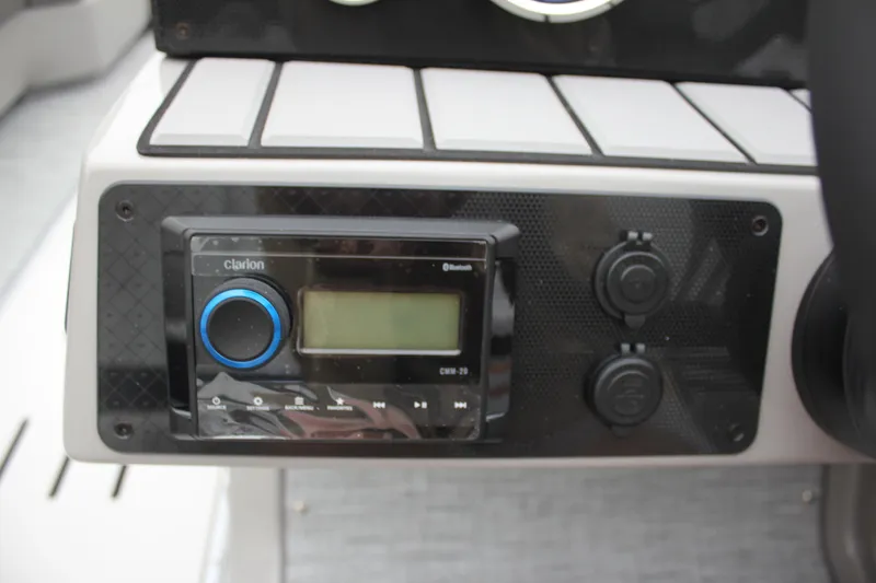 Slide: The Image of Control panel of 2024 Premier 230 SunSation Angler with Clarion Bluetooth stereo. - 28