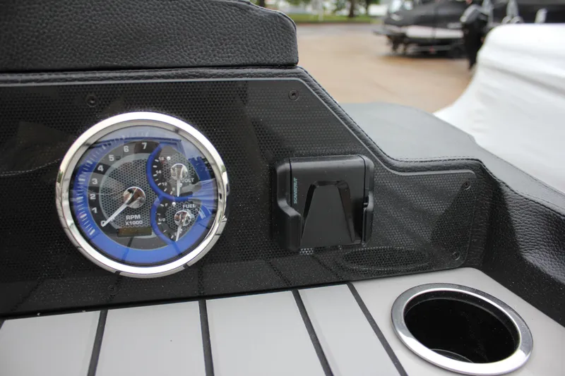 Slide: The Image of Dashboard of 2024 Premier 230 SunSation Angler with speedometer and cup holder. - 29