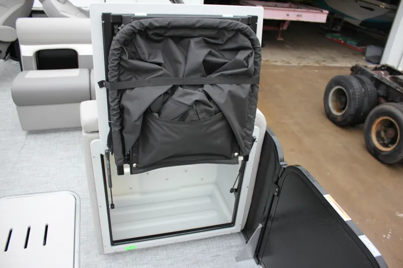 Slide: The Image of 2024 Premier 230 SunSation Angler storage compartment with foldable seat. - 34