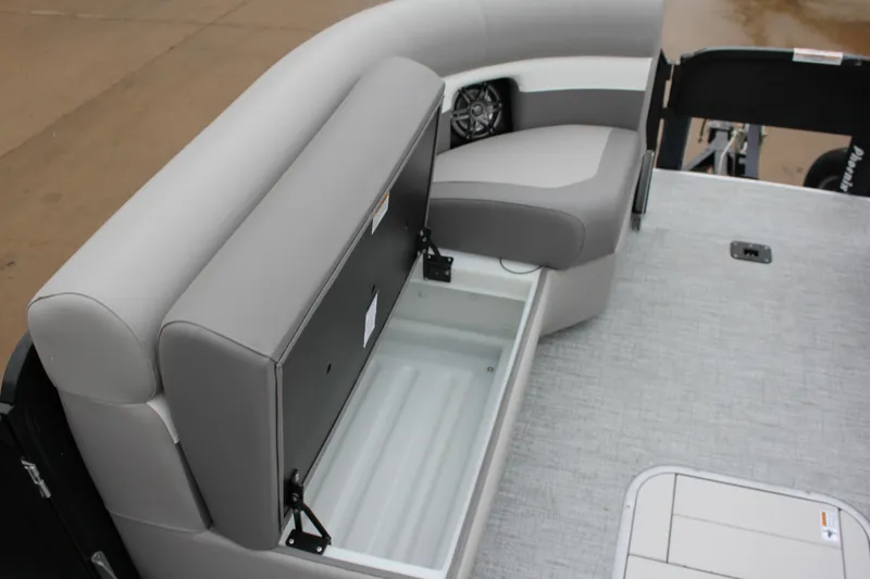 Slide: The Image of 2024 Premier 230 SunSation Angler boat with open storage compartment and cushioned seating. - 35