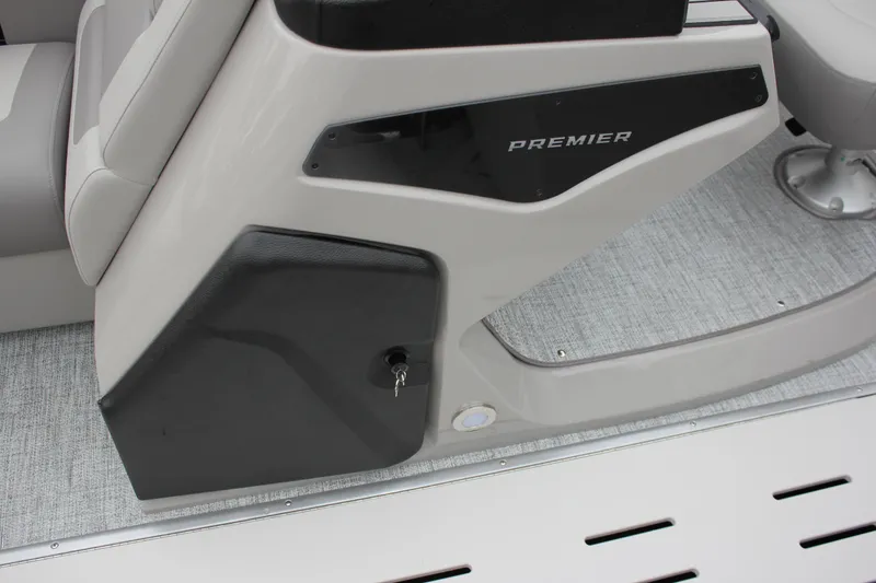 Slide: The Image of 2024 Premier 230 SunSation Angler boat console with storage compartment and key. - 36