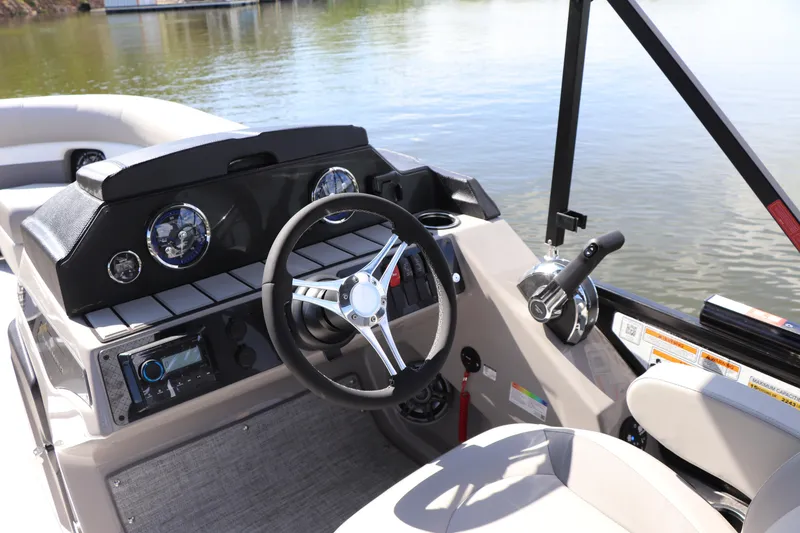 Slide: The Image of 2024 Premier 230 SunSation Angler boat dashboard with steering wheel and controls. - 4