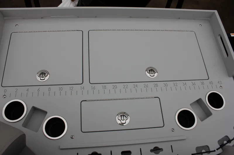 Slide: The Image of 2024 Premier 230 SunSation Angler fishing station with storage compartments and built-in measuring ruler. - 43