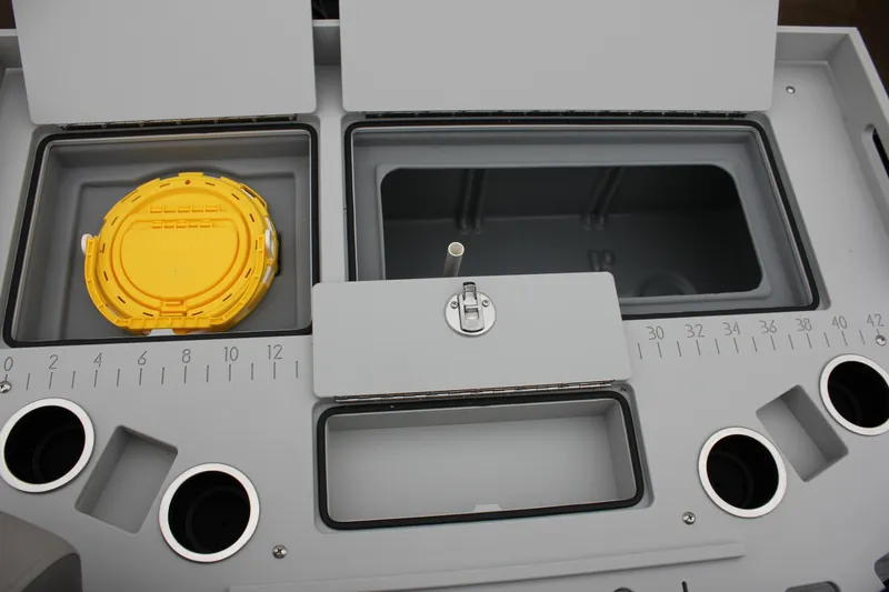 Slide: The Image of 2024 Premier 230 SunSation Angler fishing station with storage compartments and cup holders. - 44