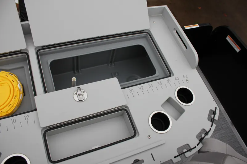 Slide: The Image of 2024 Premier 230 SunSation Angler fishing station with storage compartments and cup holders. - 45
