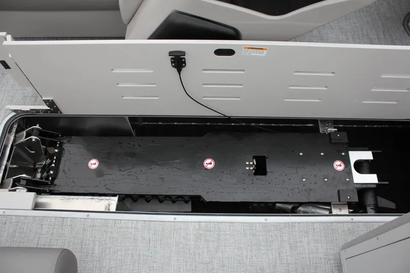 Slide: The Image of 2024 Premier 230 SunSation Angler storage compartment with open hatch. - 48