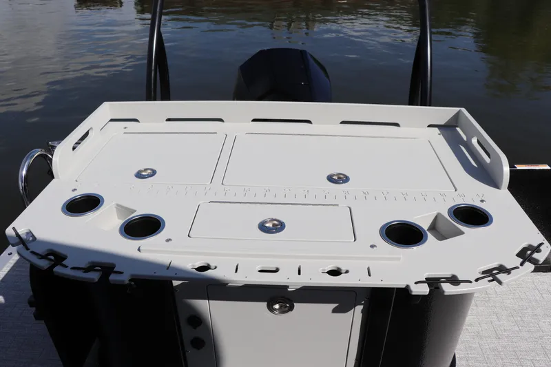 Slide: The Image of 2024 Premier 230 SunSation Angler boat deck with fishing rod holders and storage compartments. - 7