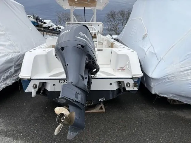 Slide: The Image of 2017 Edgewater 245 CC boat with Yamaha outboard motor, parked outdoors. - 17