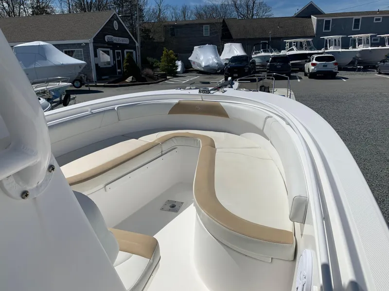 Slide: The Image of 2017 Edgewater 245 CC boat with spacious seating in a marina. - 6