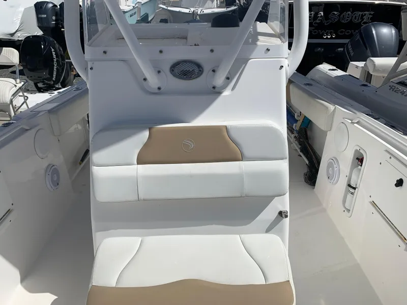 Slide: The Image of 2017 Edgewater 245 CC boat interior with white and tan seating. - 8