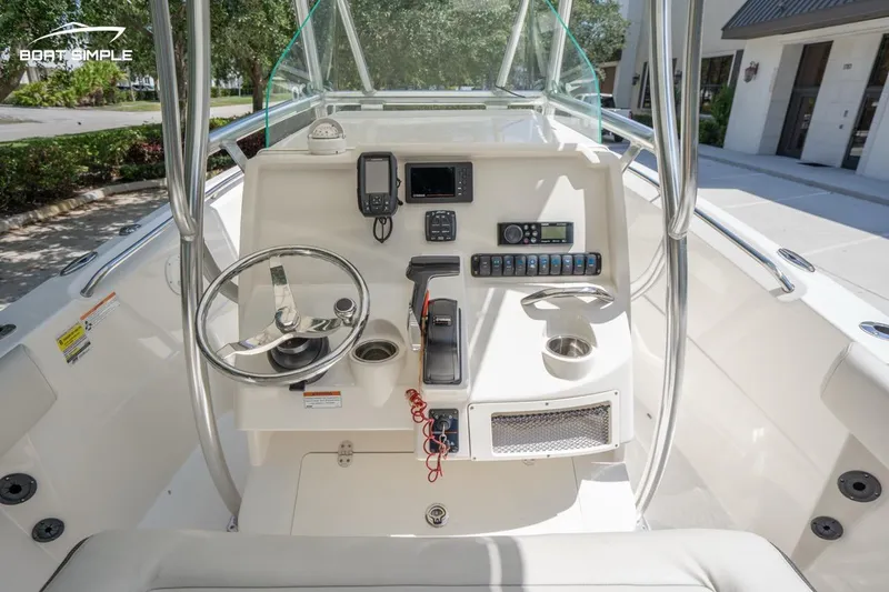 Slide: The Image of 2023 Sailfish 220 CC boat console with steering wheel and navigation equipment. - 7
