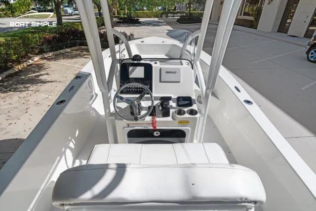 Slide: The Image of 2023 Sea Pro 199 Deep V Center Console boat interior with steering wheel and controls. - 8