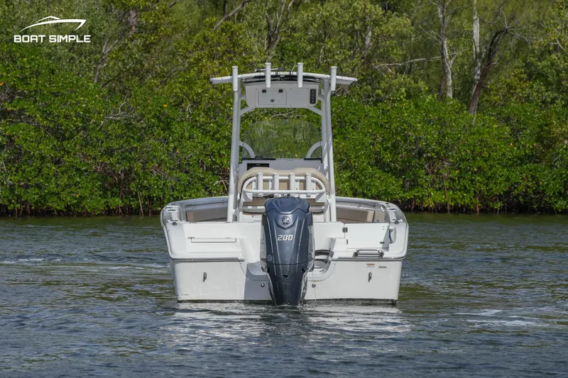 Slide: The Image of 2023 Sea Pro 219 Deep V CC boat on water, rear view with outboard motor. - 2