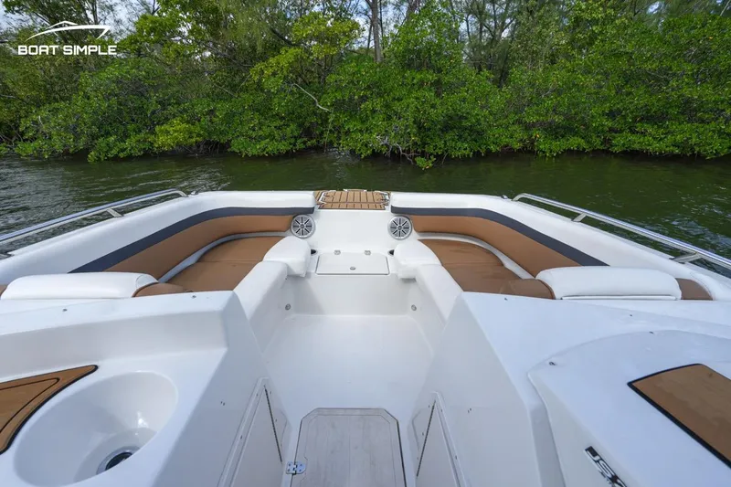 Slide: The Image of 2023 Starcraft SVX 210 OB boat interior with seating and lush greenery background. - 5