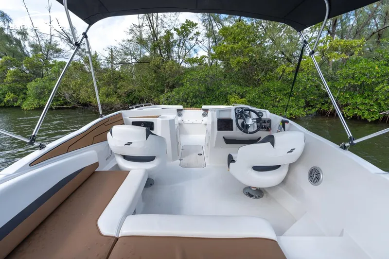Slide: The Image of 2023 Starcraft SVX 210 OB boat interior with seating and steering console. - 6