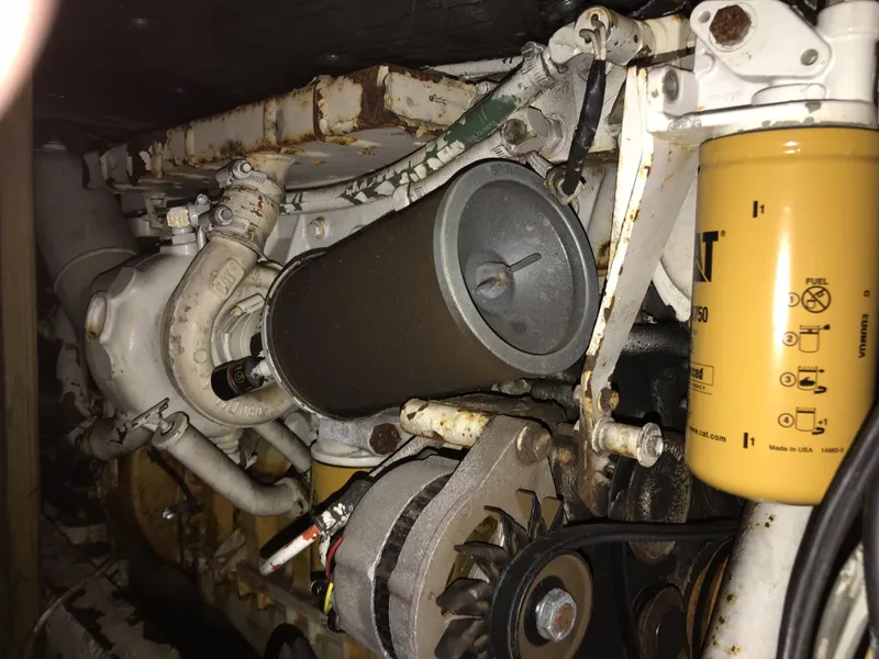 Slide: The Image of 1981 Bertram 35 Convertible engine compartment with filters and mechanical components. - 4