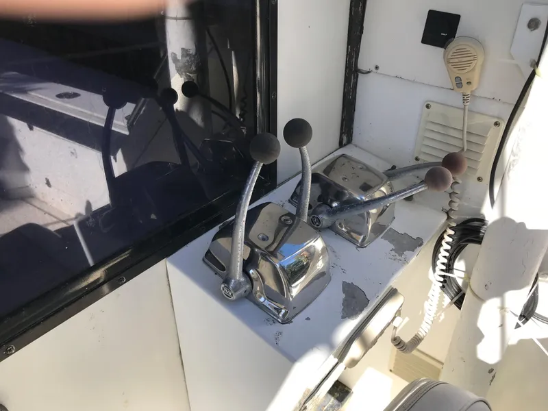 Slide: The Image of 1981 Bertram 35 Convertible boat control levers and communication equipment. - 7