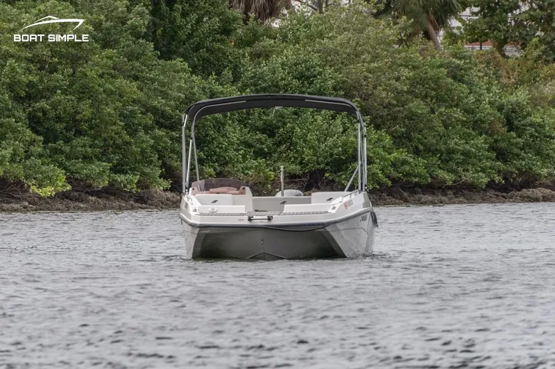 Slide: The Image of 2022 Starcraft SVX 171 OB boat on water near lush greenery. - 3