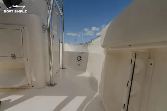 Slide: The Image of 2021 Cobia 201 Center Console boat interior with white deck and blue sky. - 11