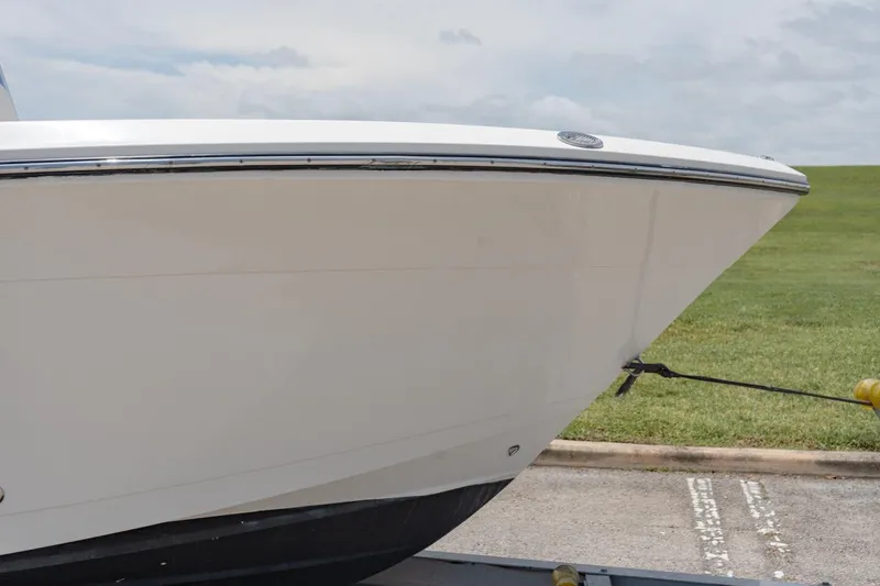 Slide: The Image of 2021 Cobia 201 Center Console boat bow on trailer. - 4