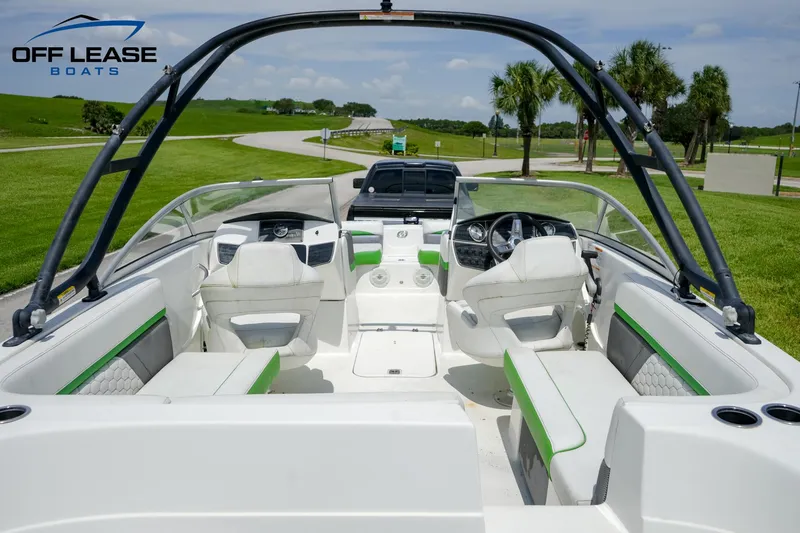 Slide: The Image of 2020 Hurricane 217 SD boat interior with white and green seating, steering wheel, and dashboard. - 4