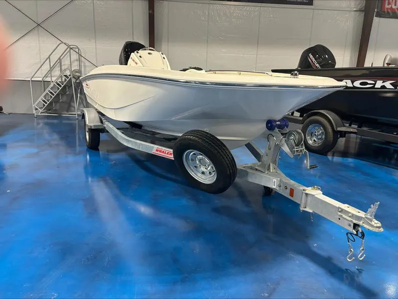 The Image of 2025 Boston Whaler 160 Super Sport boat on trailer in showroom. - 0