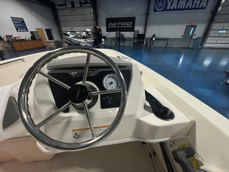 Slide: The Image of 2025 Boston Whaler 160 Super Sport steering wheel and dashboard in showroom. - 4