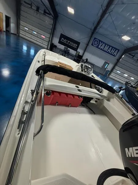 Slide: The Image of 2025 Boston Whaler 160 Super Sport boat in showroom with Yamaha and Nitro banners. - 7