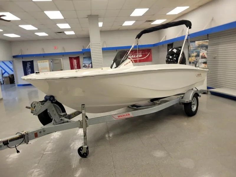 Slide: The Image of 2025 Boston Whaler 160 Super Sport boat on trailer in showroom. - 4