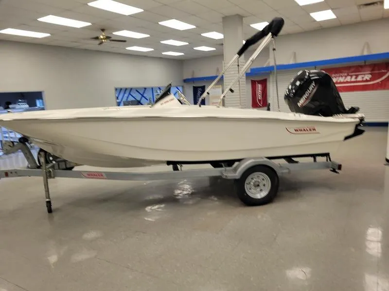 Slide: The Image of 2025 Boston Whaler 160 Super Sport boat on display in showroom. - 5