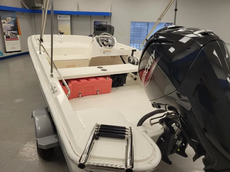 Slide: The Image of 2025 Boston Whaler 160 Super Sport boat with Mercury engine in showroom. - 6