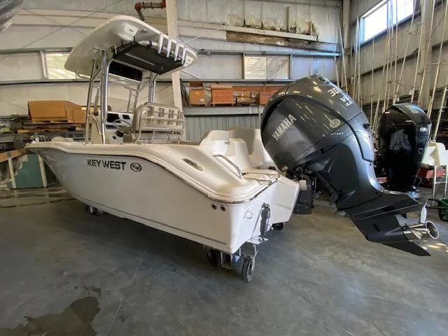 Slide: The Image of 2024 Key West 239 FS boat with Yamaha outboard motor in a storage facility. - 1