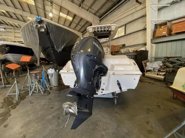 Slide: The Image of 2024 Key West 239 FS boat with Yamaha outboard motor in a storage facility. - 3