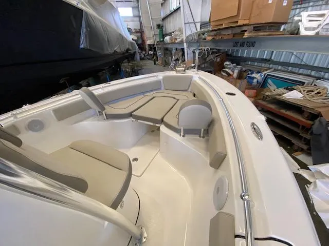 Slide: The Image of 2024 Key West 239 FS boat interior with beige seating in a storage facility. - 6