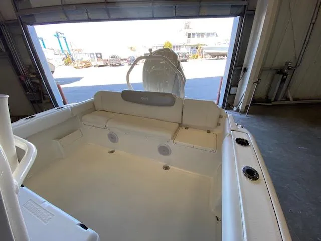 Slide: The Image of 2024 Key West 239 FS boat interior, featuring spacious seating and modern design in a garage setting. - 11