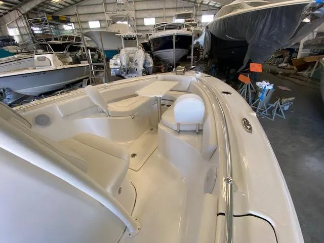 Slide: The Image of 2024 Key West 239 FS boat interior in a storage facility, showcasing seating and table. - 12
