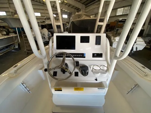Slide: The Image of 2024 Key West 239 FS boat console with steering wheel and electronic controls in a showroom. - 5