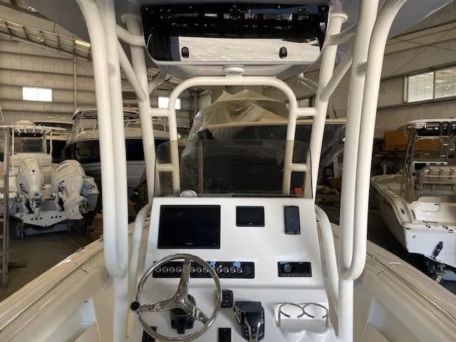 Slide: The Image of 2024 Key West 239 FS boat dashboard with steering wheel and electronic controls in a showroom. - 6