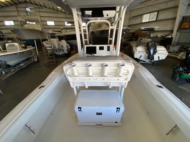 Slide: The Image of 2024 Key West 239 FS boat interior in a storage facility, featuring seating and a cooler. - 7