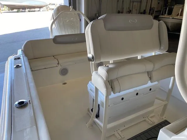 Slide: The Image of 2024 Key West 239 FS boat interior with cushioned seating and storage. - 9