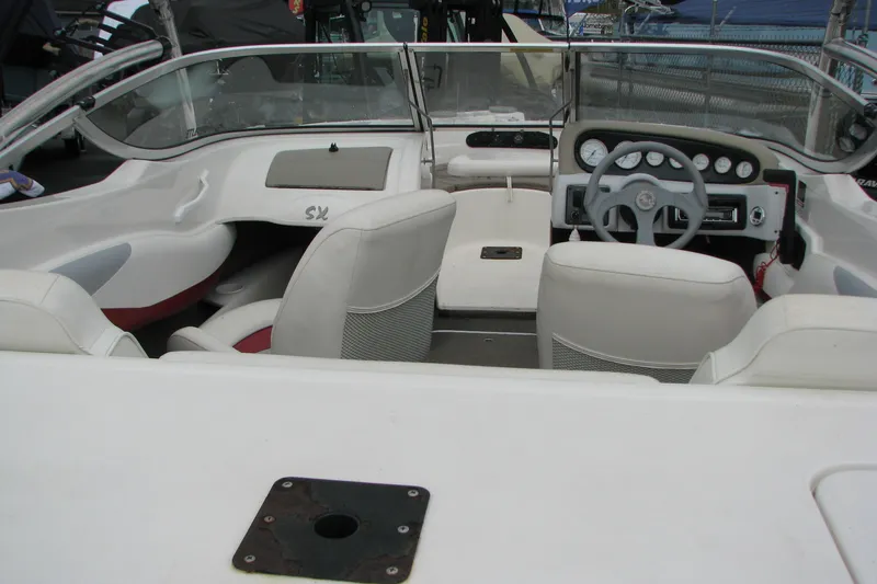 Slide: The Image of 1999 Glastron 175SX boat interior with white seating and dashboard controls. - 16