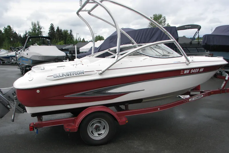 Slide: The Image of 1999 Glastron 175SX boat on trailer, red and white design, parked outdoors. - 17