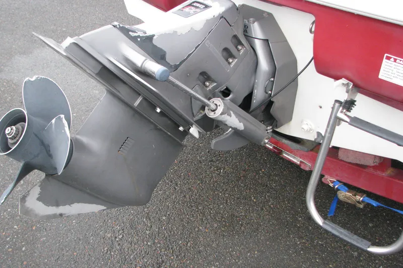 Slide: The Image of 1999 Glastron 175SX boat outboard motor and propeller on wet pavement. - 18