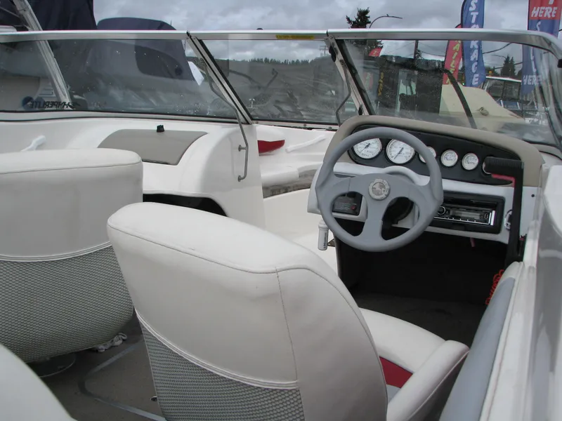 Slide: The Image of 1999 Glastron 175SX boat with red cover and trailer, parked outdoors. - 3