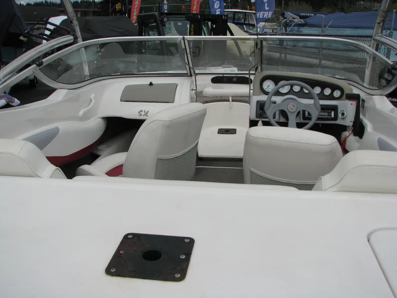 Slide: The Image of 1999 Glastron 175SX boat on trailer, displayed outdoors at a dealership. - 5