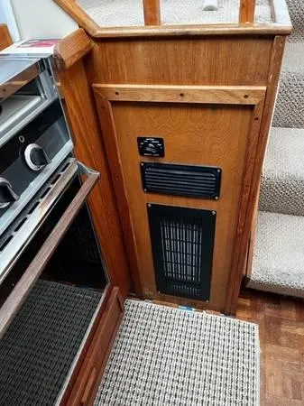 Slide: The Image of 1982 Uniflite Sport Fisher interior with wood paneling and carpeted stairs. - 10